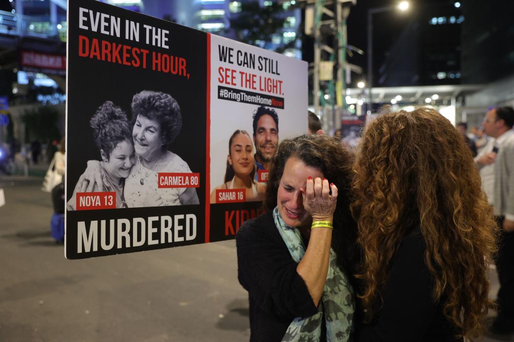 Hadas Kalderon, the mother of Israeli hostage Sahar, and her husband Ofer Kalderon, cry during a protest calling on the government to sign an agreement with Hamas for a release of hostages.