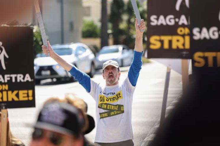 SAG-AFTRA member Jim Kulick reacts as he and other SAG-AFTRA members walk the picket line on the 100th day of their ongoing strike, outside Paramount Studios in Los Angeles, California, U.S., October 20, 2023