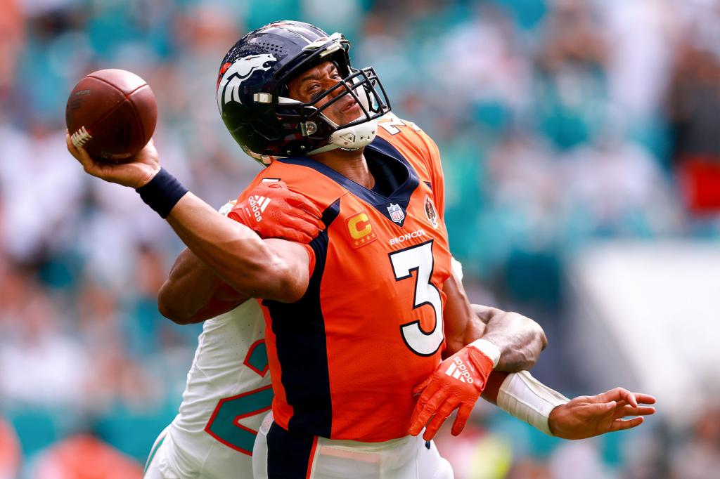 Justin Bethel #20 of the Miami Dolphins sacks Russell Wilson #3 of the Denver Broncos during the third quarter at Hard Rock Stadium on September 24, 2023 in Miami Gardens, Florida. 