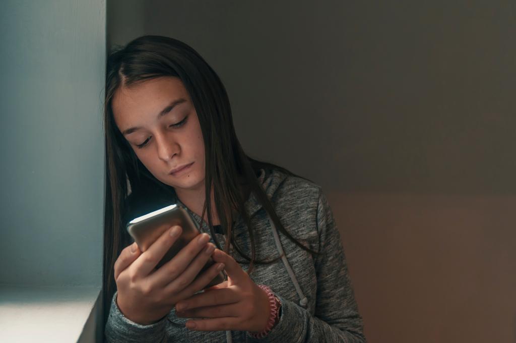 Teen girl looking at phone