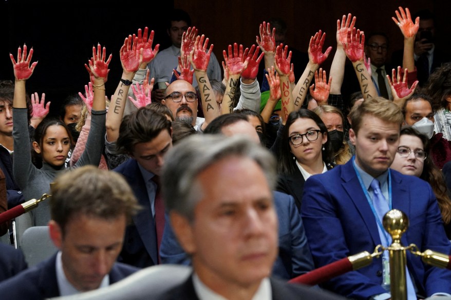 Anti-war protesters raise their "bloody" hands behind Secretary of State Antony Blinken during a Senate Appropriations Committee hearing on President Biden's $106B national security supplemental funding request to support Israel and Ukraine, as well as bolster border security, on Capitol Hill in Washington on Oct. 31, 2023.  