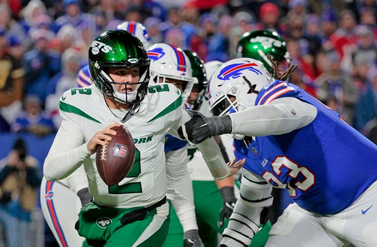 Zach Wilson #2 of the New York Jets runs out of the pocket as Linval Joseph #93 of the Buffalo Bills rushes during the third quarter at Highmark Stadium.