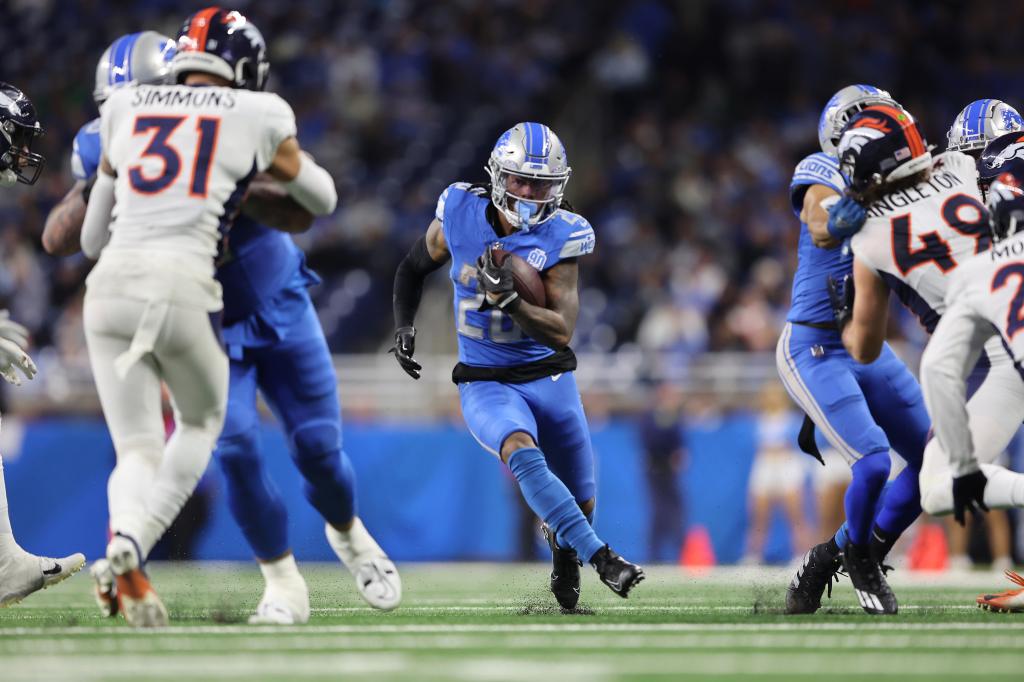 Jahmyr Gibbs #26 of the Detroit Lions runs the ball during the fourth quarter against the Denver Broncos at Ford Field