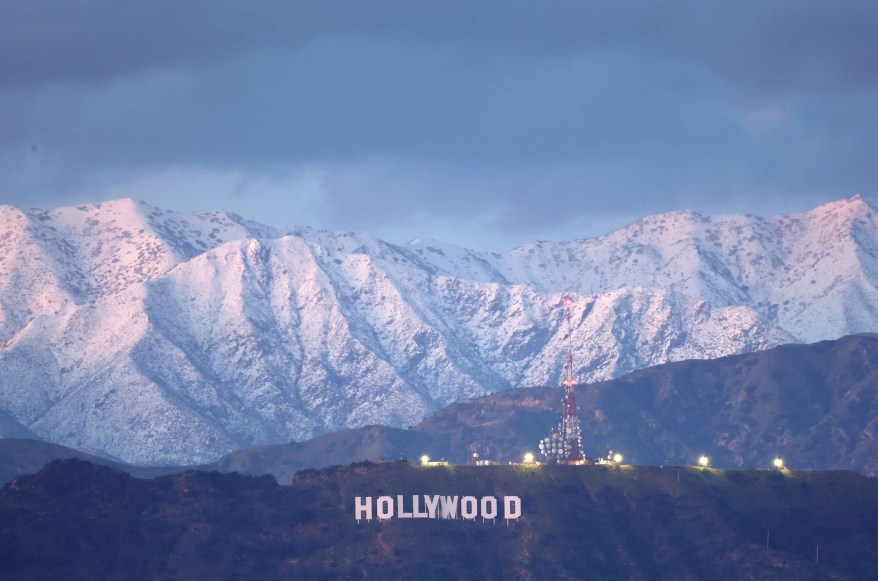 The Hollywood sign stands in front of snow-covered mountains after another winter storm hit Southern California on March 1, 2023 in Los Angeles.