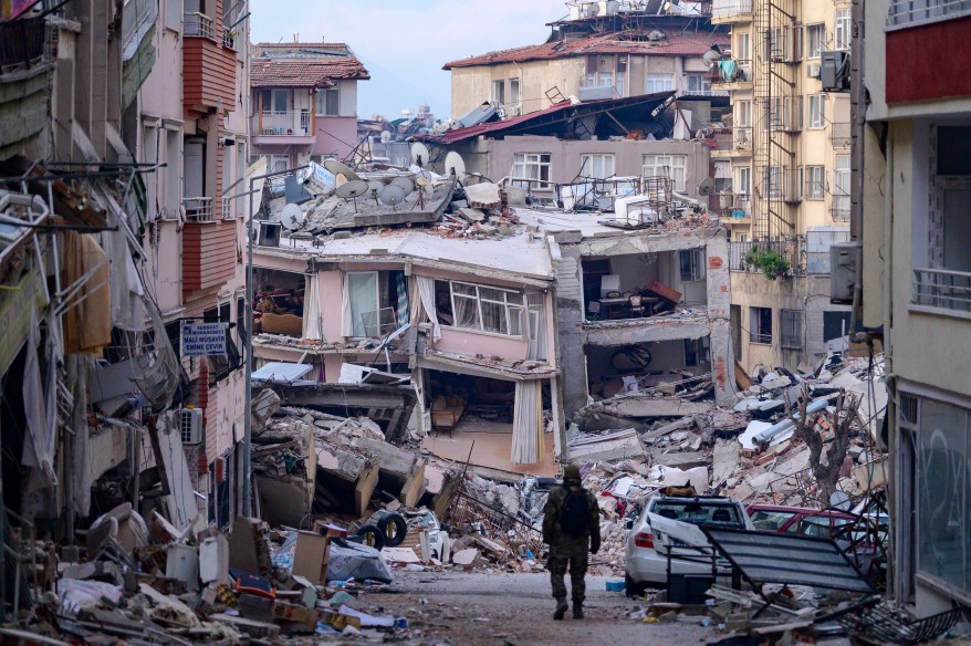 A Turkish soldier walks among destroyed buildings in Hatay, Turkey, on Feb. 12, 2023, after a 7.8-magnitude earthquake struck the country's southeast.