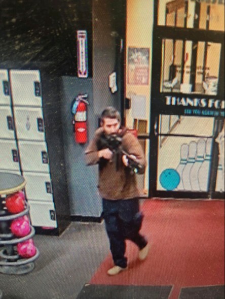 Robert Card points a gun as he enters Sparetime Recreation in Lewiston, Maine, on Wednesday, Oct. 25, 2023, as seen in an image released by the Androscoggin County Sheriff's Office. Card killed 18 people and was found dead himself after a tense, days-long manhunt