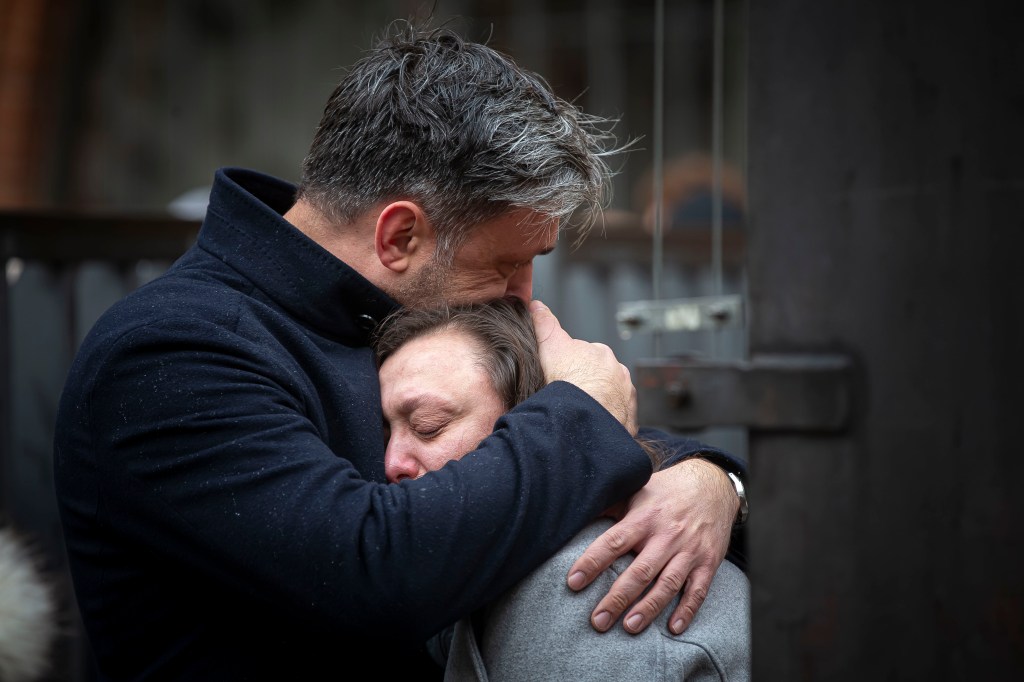 People mourn outside the Charles University building following a mass shooting yesterday, on December 22, 2023 