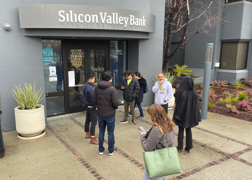 People line up outside of a shuttered Silicon Valley Bank (SVB) headquarters on March 10, 2023 in Santa Clara, California. Silicon Valley Bank was shut down on Friday morning by California regulators and was put in control of the U.S. Federal Deposit Insurance Corporation.