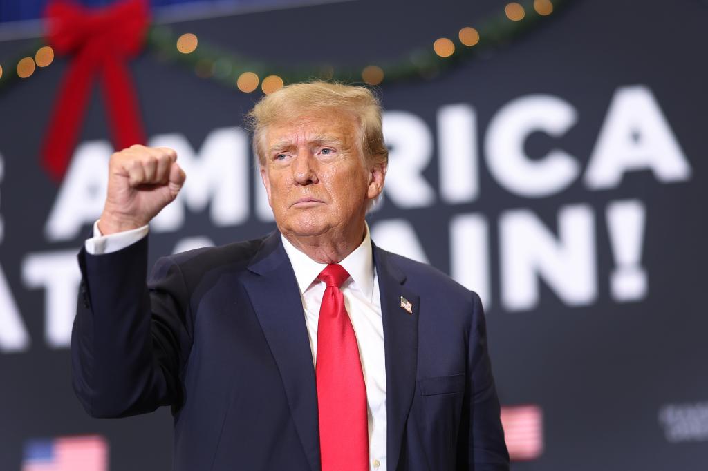 Republican presidential candidate and former U.S. President Donald Trump gestures as he wraps up a campaign event on December 19, 2023 in Waterloo, Iowa.