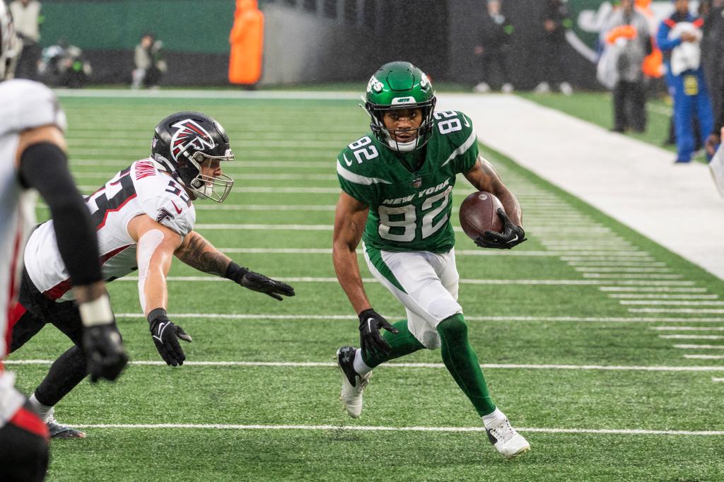 Xavier Gipson #82 of the New York Jets runs the ball as Nate Landman #53 of the Atlanta Falcons dives for a tackle in the first half at MetLife Stadium, Sunday, Dec. 3, 2023, in East Rutherford, NJ. 