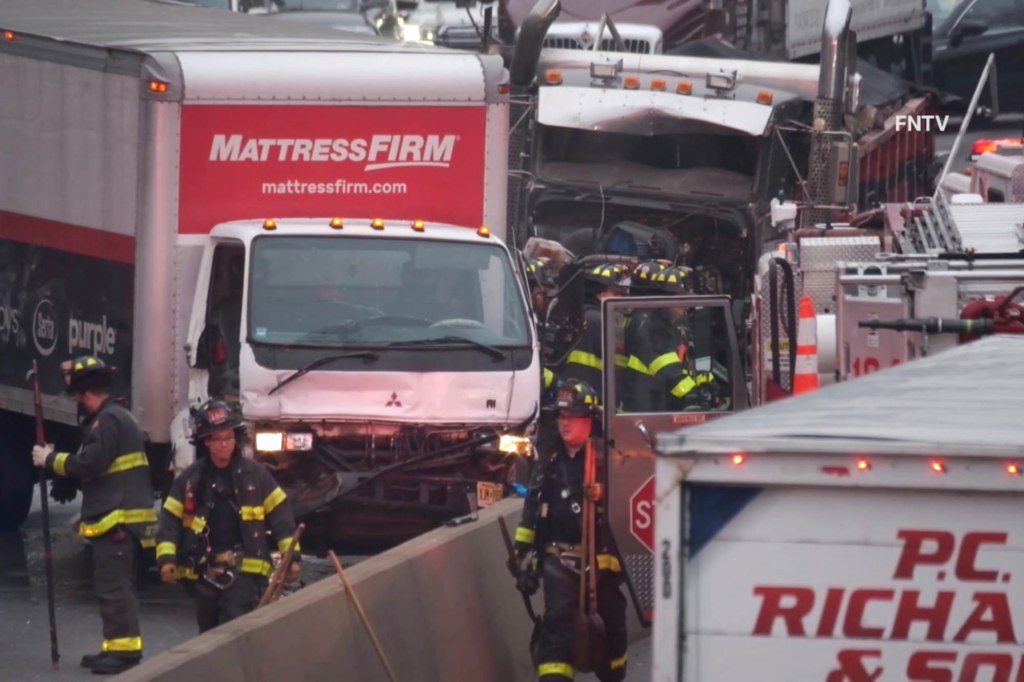 Firefighters navigate traffic and the wreckage following the Saturday morning crash along the Long Island Expressway.