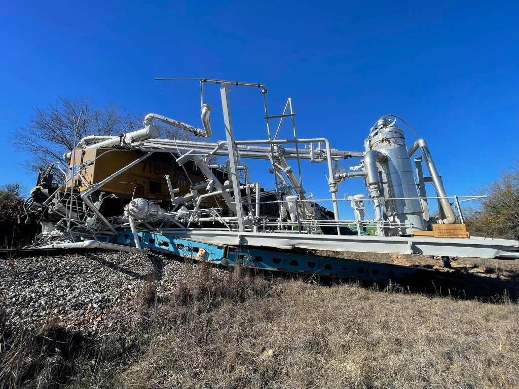 The trailer was sitting trapped on the tracks near Aledo when a Union Pacific train rammed into it. 