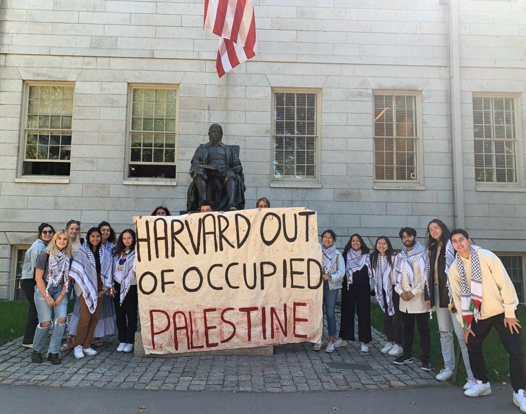 Students with a sign saying: "Harvard out of occupied Palestine."