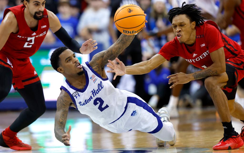 Al-Amir Dawes dives for a loose ball in front of Jamichael Davis (right) during Seton Hall's loss to Rutgers.