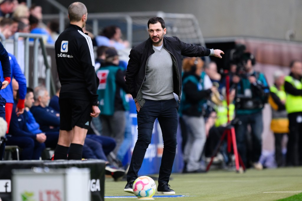 Sandro Schwarz of Berlin speaks to Fourth Official Christian Leicher (L) during the Bundesliga match between TSG Hoffenheim and Hertha BSC.