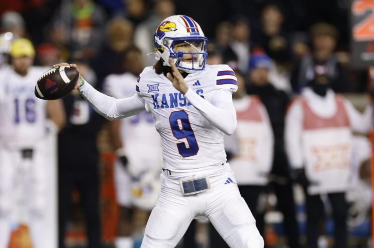 Kansas Jayhawks quarterback Jason Bean (9) passes the ball during a college football game against the Cincinnati Bearcats.