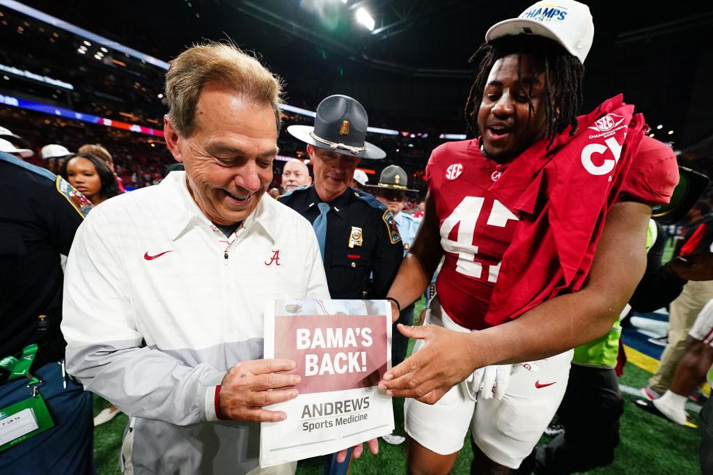 Nick Saban celebrates with defensive lineman James Smith after Alabama's win over Georgia in the SEC Championship game.