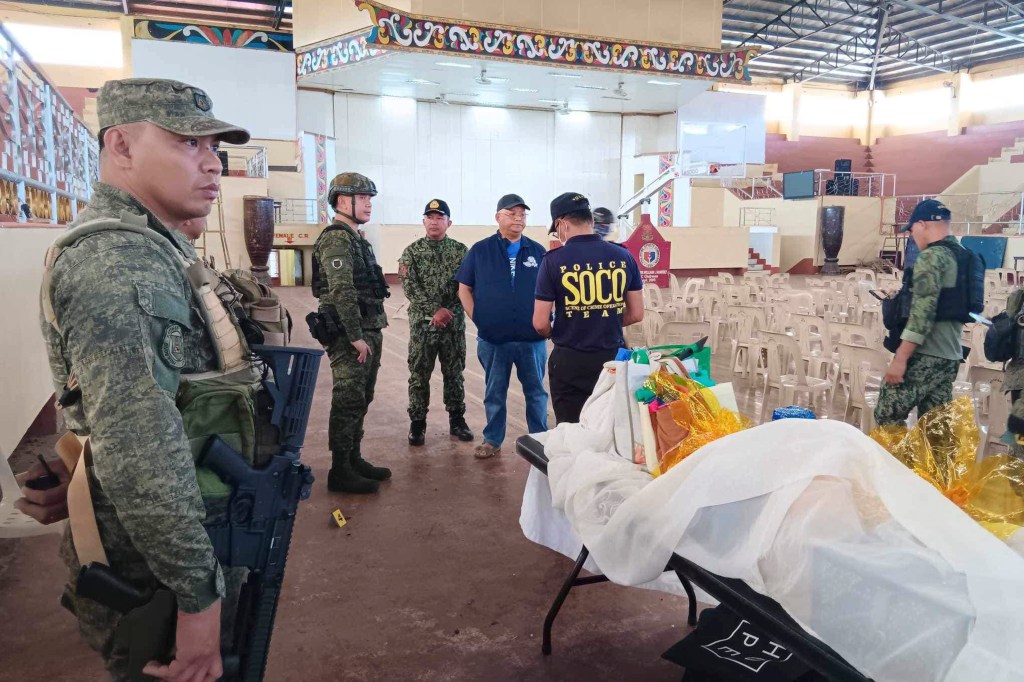  law enforcers conduct an investigation at the site of an explosion in Marawi city, southern Philippines on Sunday Dec. 3, 2023. 