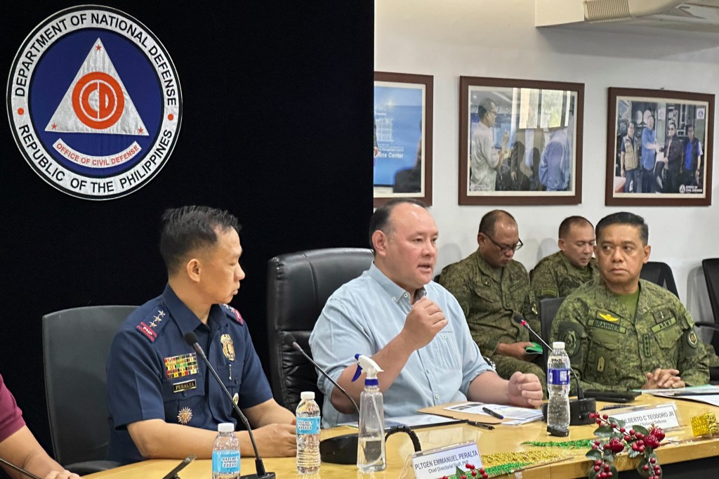 Philippine Defense Secretary Gilbert Teodoro, center, talks beside Philippine Military Chief Gen. Romeo Brawner Jr., right, as they hold a press conference in Quezon city, Philippines on Sunday Dec. 3, 2023. 