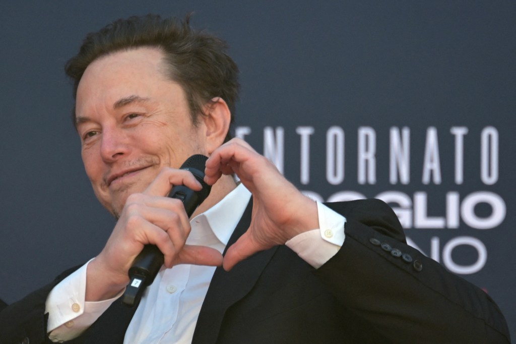 Elon Musk makes a heart with his hands during the Atreju political meeting organised by the young militants of Italian right wing party Brothers of Italy (Fratelli d'Italia) on December 16, 2023 at the Sant'Angelo Castle in Rome.