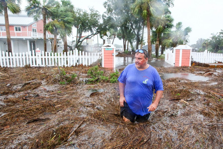 Daniel Dickert wades through water in front of his home in Steinhatchee, Florida. The Steinhatchee River remained out of its banks on Wednesday, Aug 30, 2023, after the arrival of Hurricane Idalia on Florida's west coast.