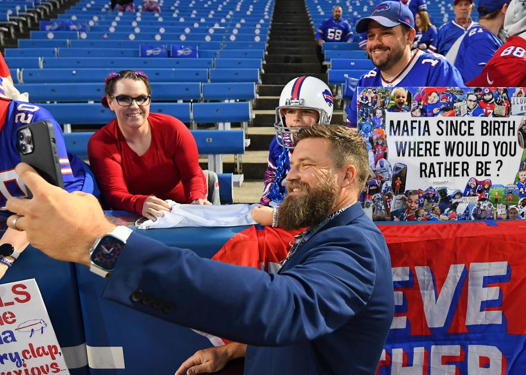 Ryan Fitzpatrick takes a selfie with a fan prior to the game between the Tampa Bay Buccaneers and the Buffalo Bills at Highmark Stadium on October 26, 2023 in Orchard Park, New York. 