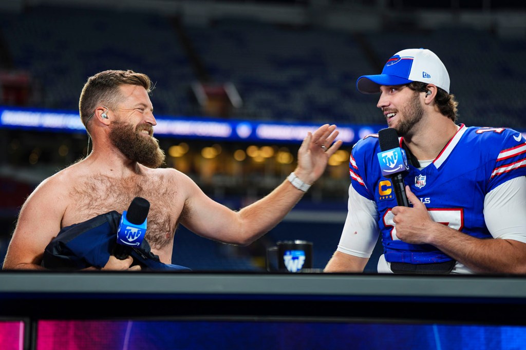 Ryan Fitzpatrick talks with Buffalo Bills quarterback Josh Allen on set of the Amazon Prime "Thursday Night Football" postgame show after a game against the Tampa Bay Buccaneers at Highmark Stadium on October 26, 2023 in Orchard Park, New York. 