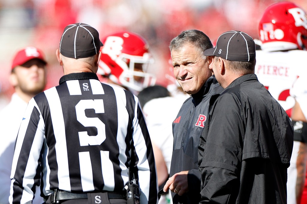 Greg Schiano head coach of the Rutgers Scarlet Knights talks with officials during a replay in the fourth quarter of the game against the Wisconsin Badgers