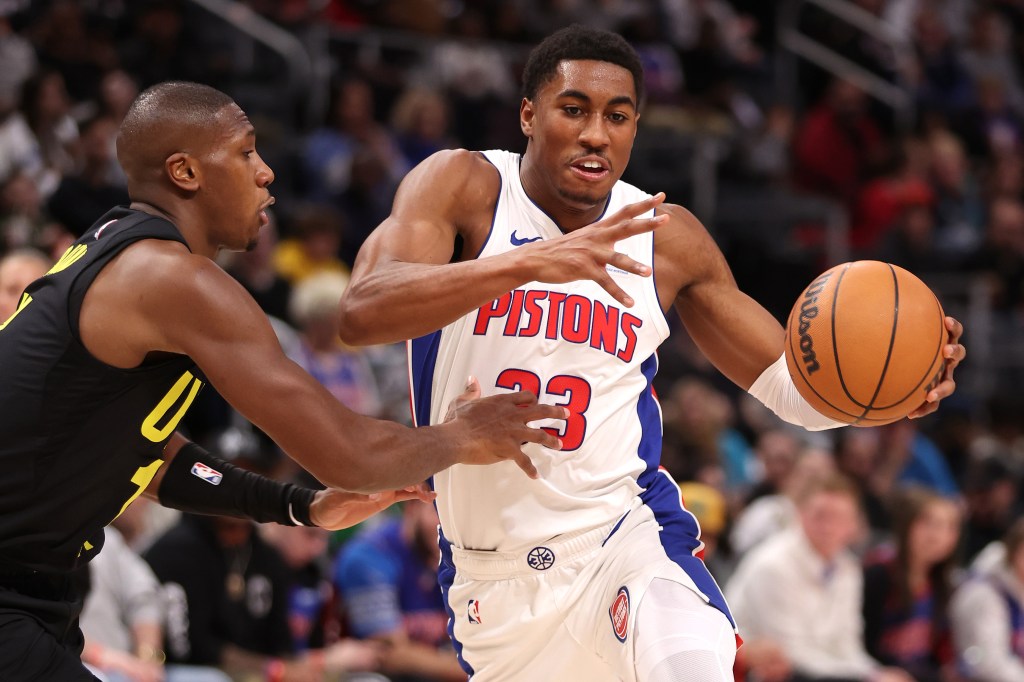 Jaden Ivey #23 of the Detroit Pistons tries to drive around Kris Dunn #11 of the Utah Jazz.