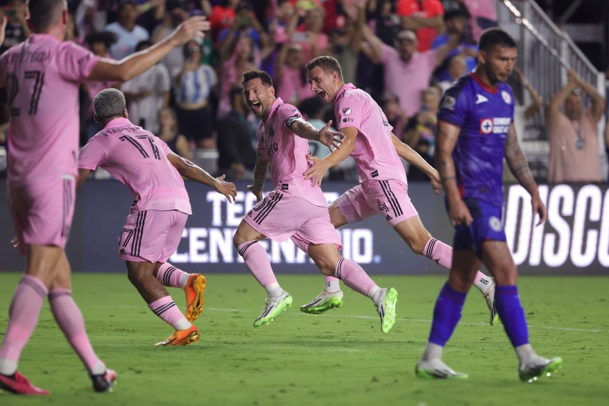 Lionel Messi of Inter Miami celebrates with teammates after kicking the winning goal during his debut game against Cruz Azul at DRV PNK Stadium on July 21, 2023 in Fort Lauderdale, Florida.