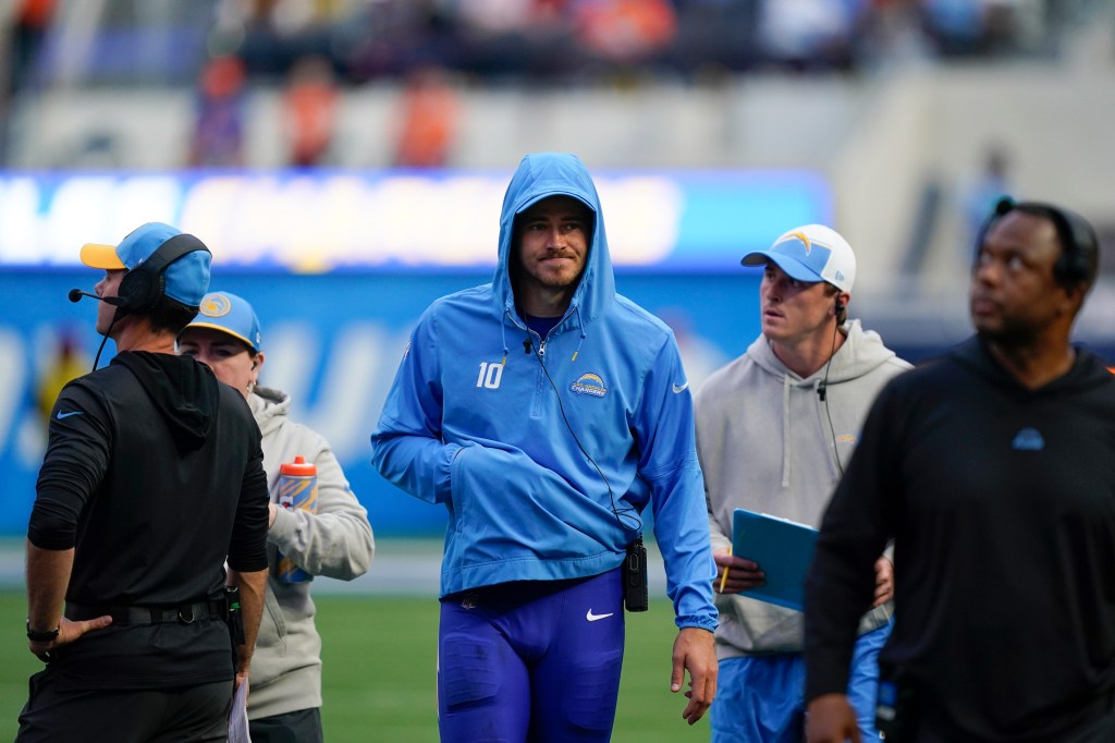 Justin Herbert walks on the sidelines after injuring his finger in the Chargers-Broncos game on Dec. 10. 