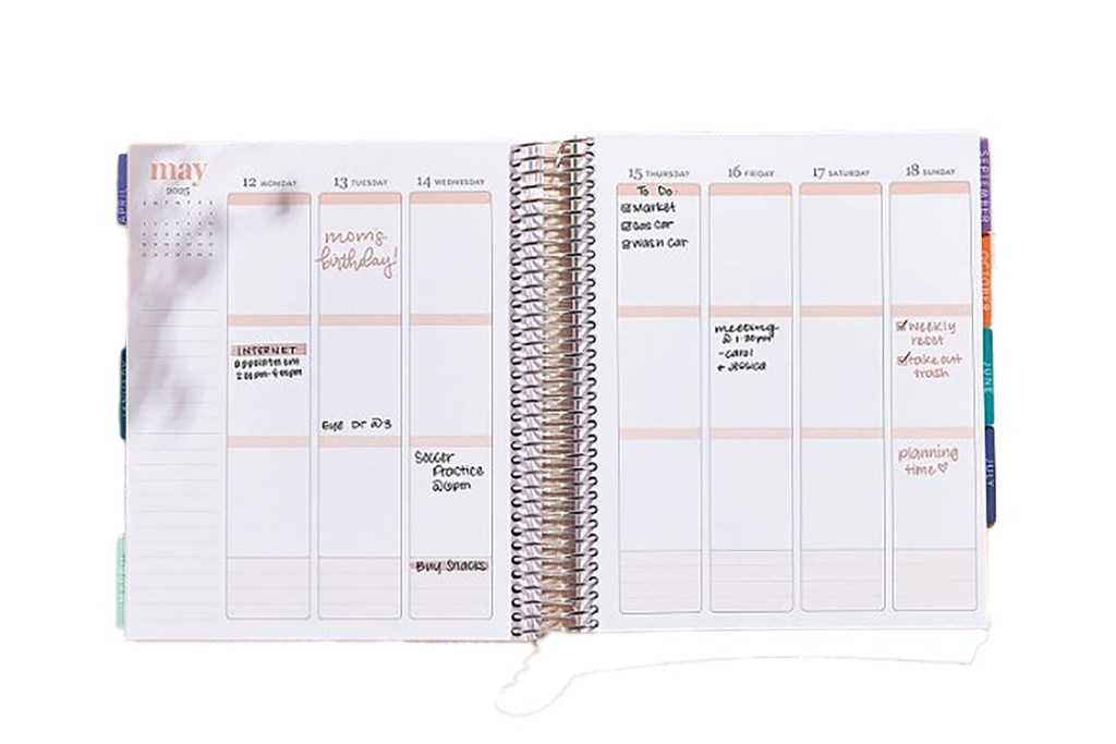 A spiral bound planner with a pen