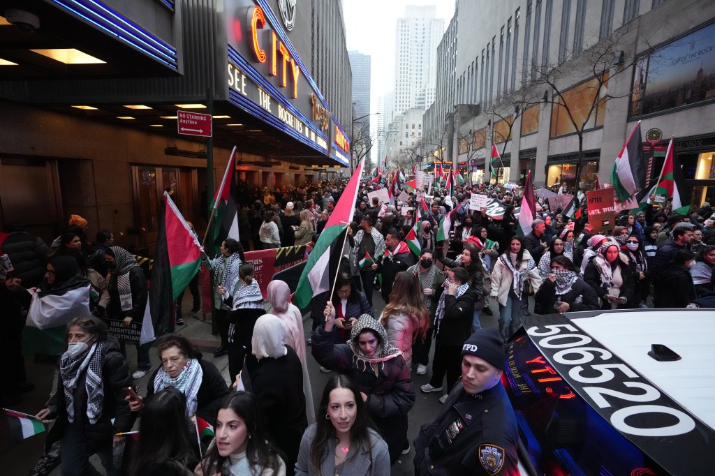 Pro-Palestine protestors march during a Christmas rally.