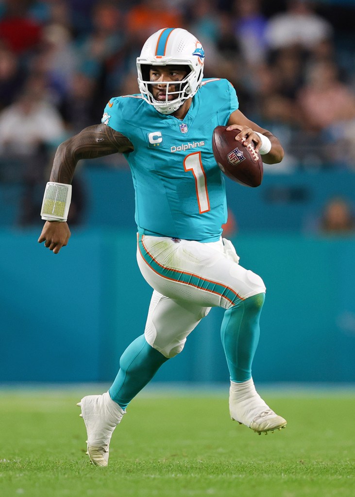 Dolphins quarterback Tua Tagovailoa carries the ball against the Tennessee Titans during the second quarter of the game at Hard Rock Stadium on December 11, 2023 in Miami Gardens, Florida.  