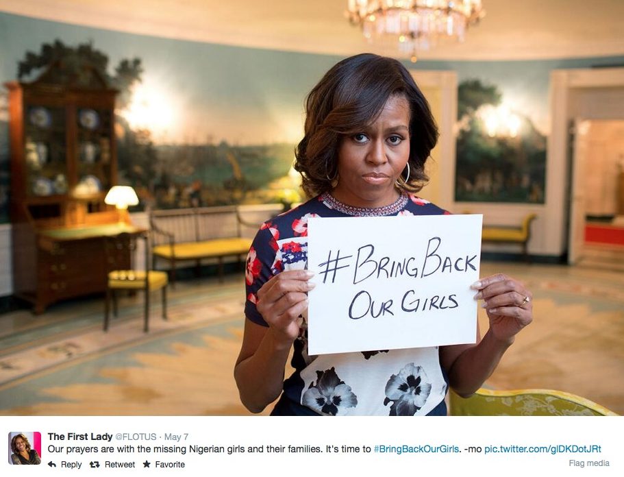 Michelle Obama in he White House holding a sign saying #BringBackOurGirls