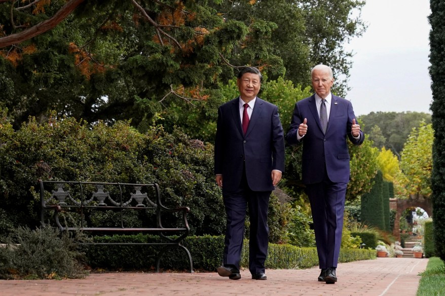 Joe Biden gives a thumbs-up as he walks with Chinese President Xi Jinping at Filoli estate on the sidelines of the Asia-Pacific Economic Cooperation (APEC) summit, in Woodside, Calif., on Nov. 15, 2023. 