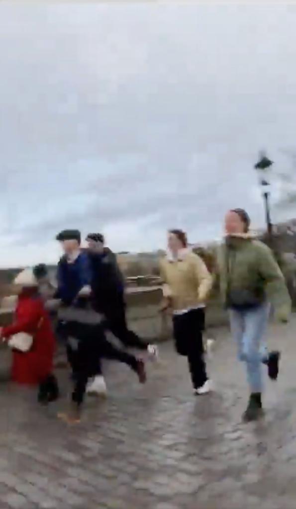 Video posted to Twitter shows people running on a bridge in Prague