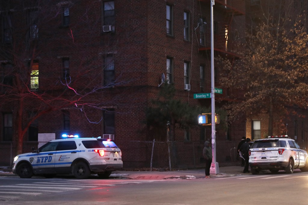 NYPD cars parked outside a large apartment building on the corner of New York Avenue and Beverley Road