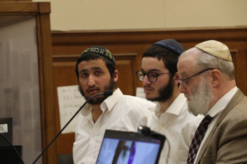 Henachem Mulakando and Shmuel Malka with their lawyer in court