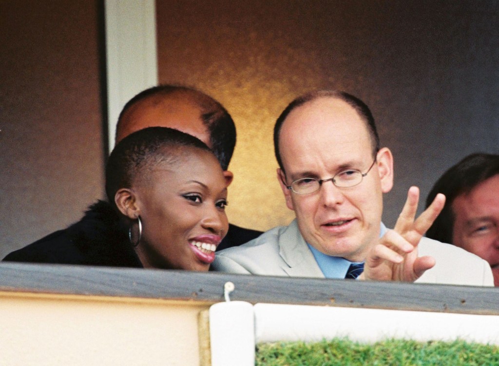 A photo of Prince Albert and Nicole Coste sitting close together at a sporting event.