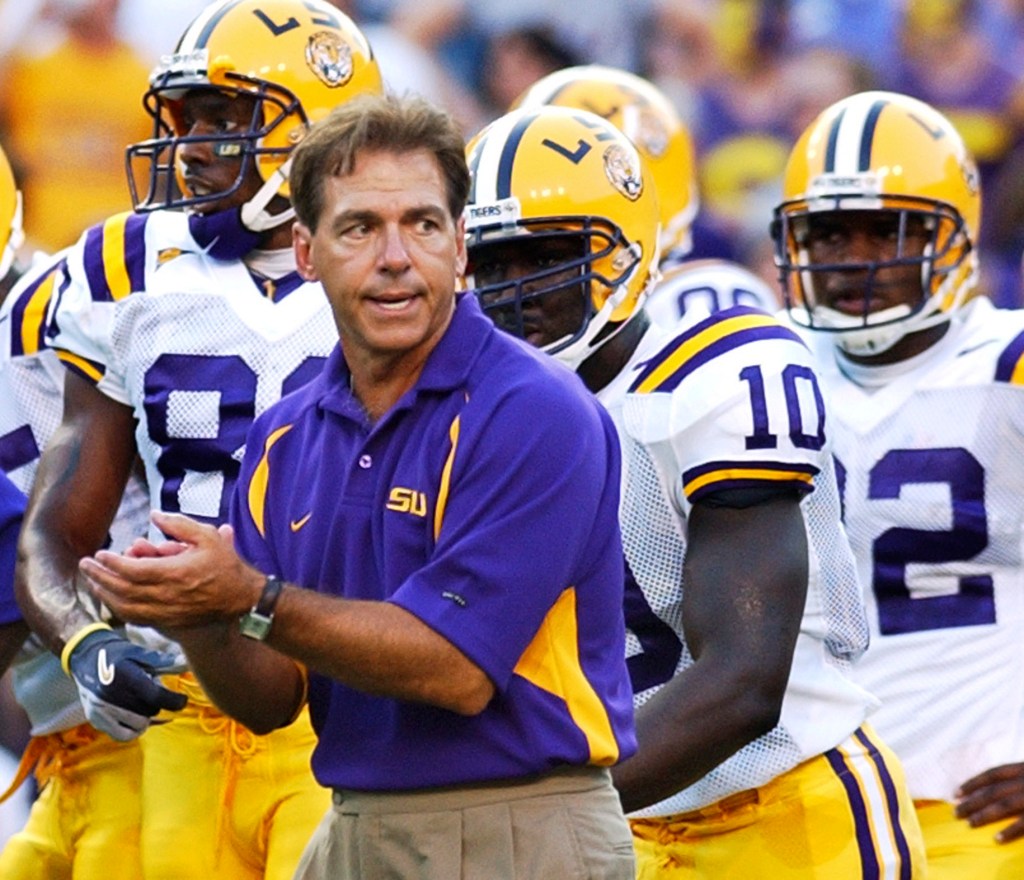 LSU coach Nick Saban encourages his players before an NCAA college football game against Arkansas State