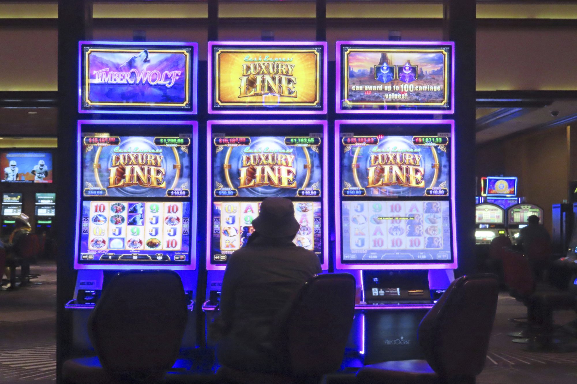 A gambler plays a slot machine at Harrah's casino in Atlantic City, N.J. on Sept. 29, 2023. 