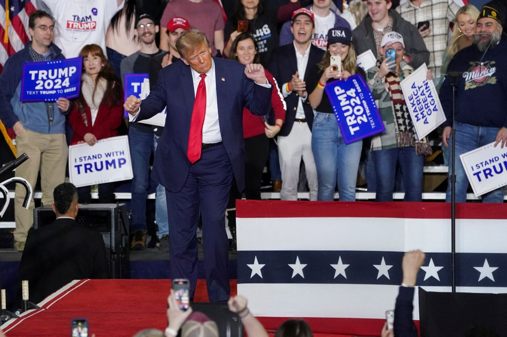 Donald Trump dances on stage at a Saturday rally in Manchester ahead of the New Hampshire primary.