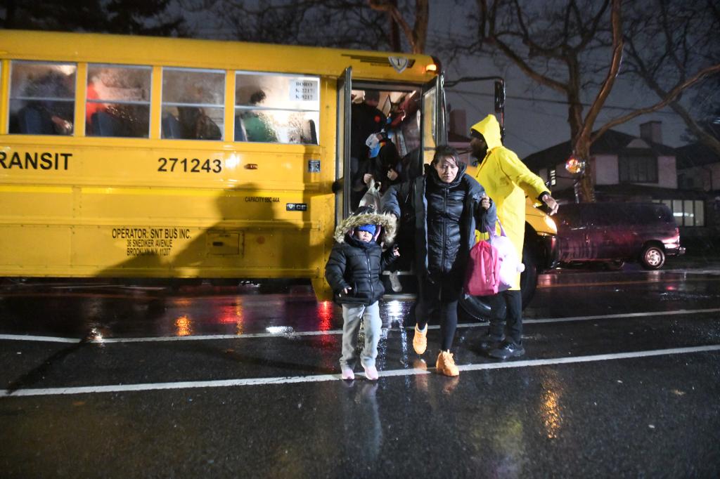 Around 1,900 migrants were moved into James Madison High School in Brooklyn on Tuesday as a precaution against torrential rains and powerful winds that threatened to collapse a massive migrant tent at Floyd Bennett Field.