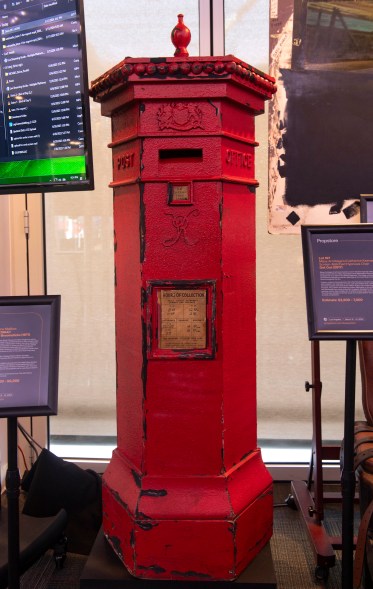 A red post box with a digital display.