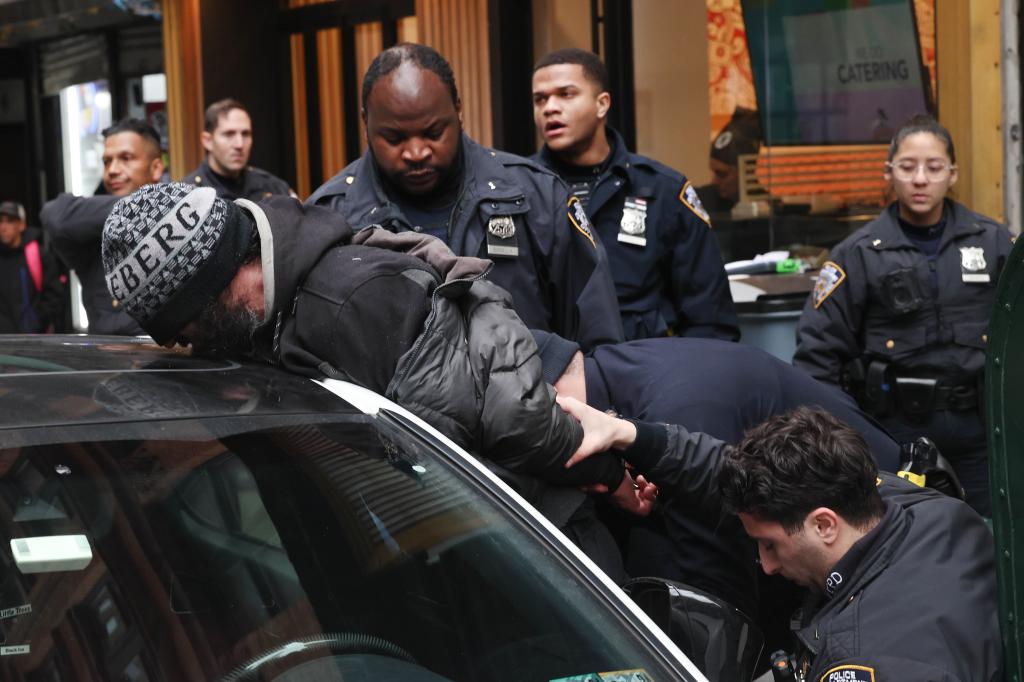 NYPD 1st pct officers frisking a suspect at John St and Nassau St