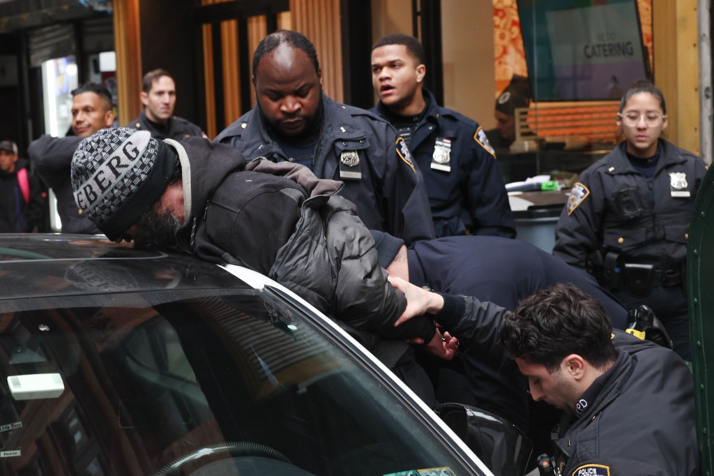 NYPD 1st pct officers frisking a suspect at John St and Nassau St