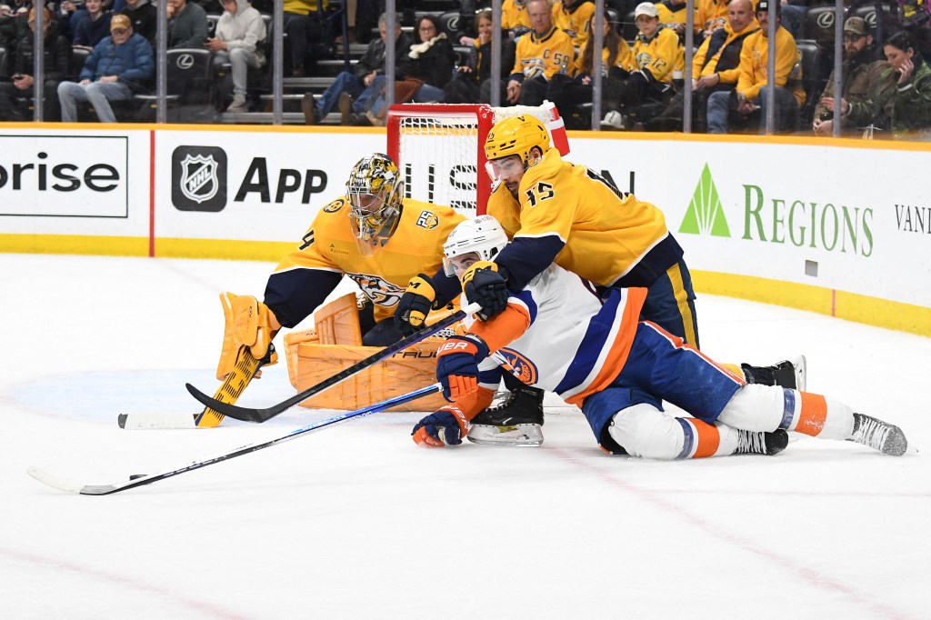 Kyle Palmieri loses the puck as he is defended by Alexandre Carrier (right) during the second period of the Islanders' 3-1 loss to the Predators.