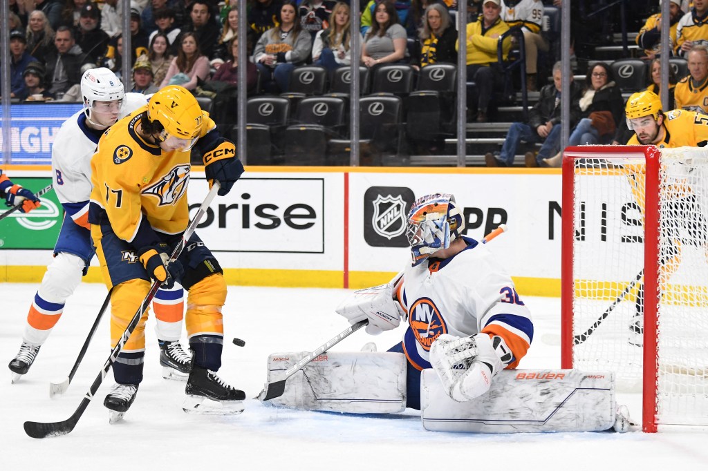 Luke Evangelista, who scored later in the third period, deflects a shot wide of Ilya Sorokin during the Islanders' loss.