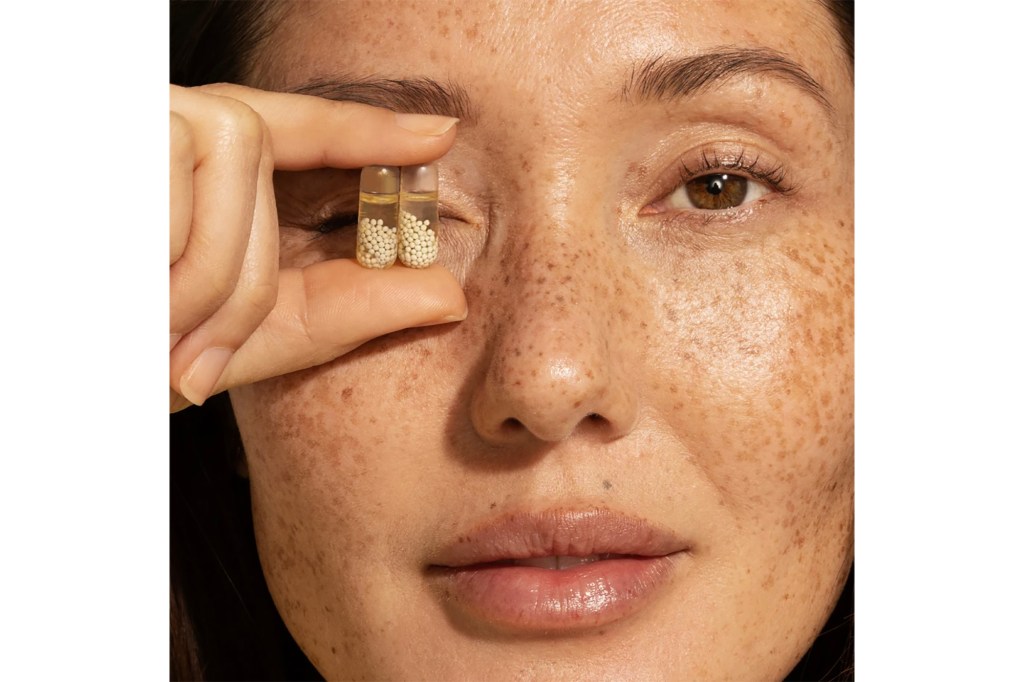 A woman holding a pill.